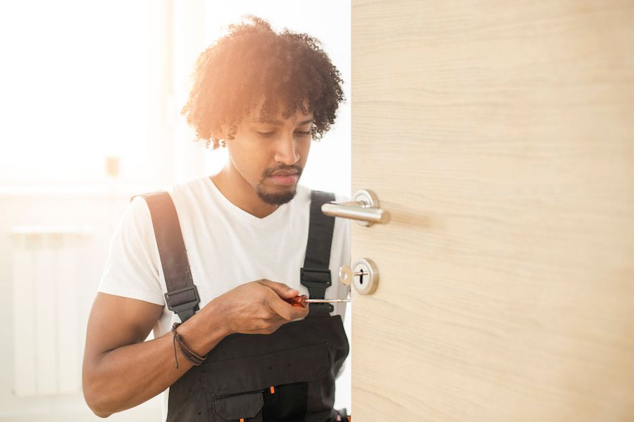 A locksmith works on a door. Know the Hardware You Have.